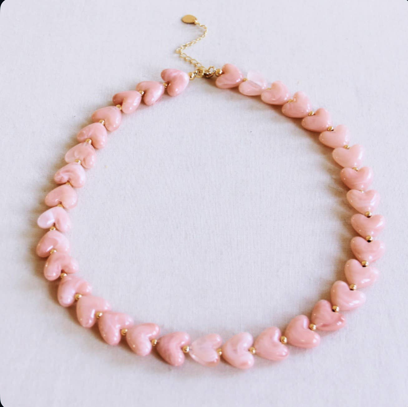 Beaded necklace of resin hearts - light pink